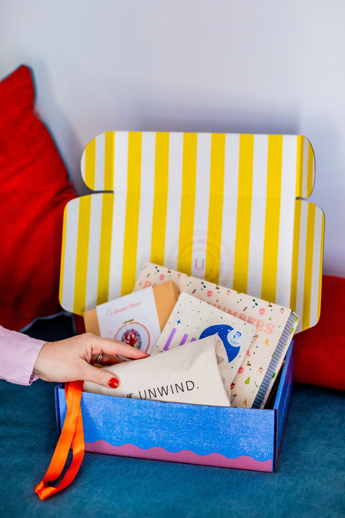 Ingredients of Unwind Co Box #1, filled with creative projects like paint by numbers and embroidery. 